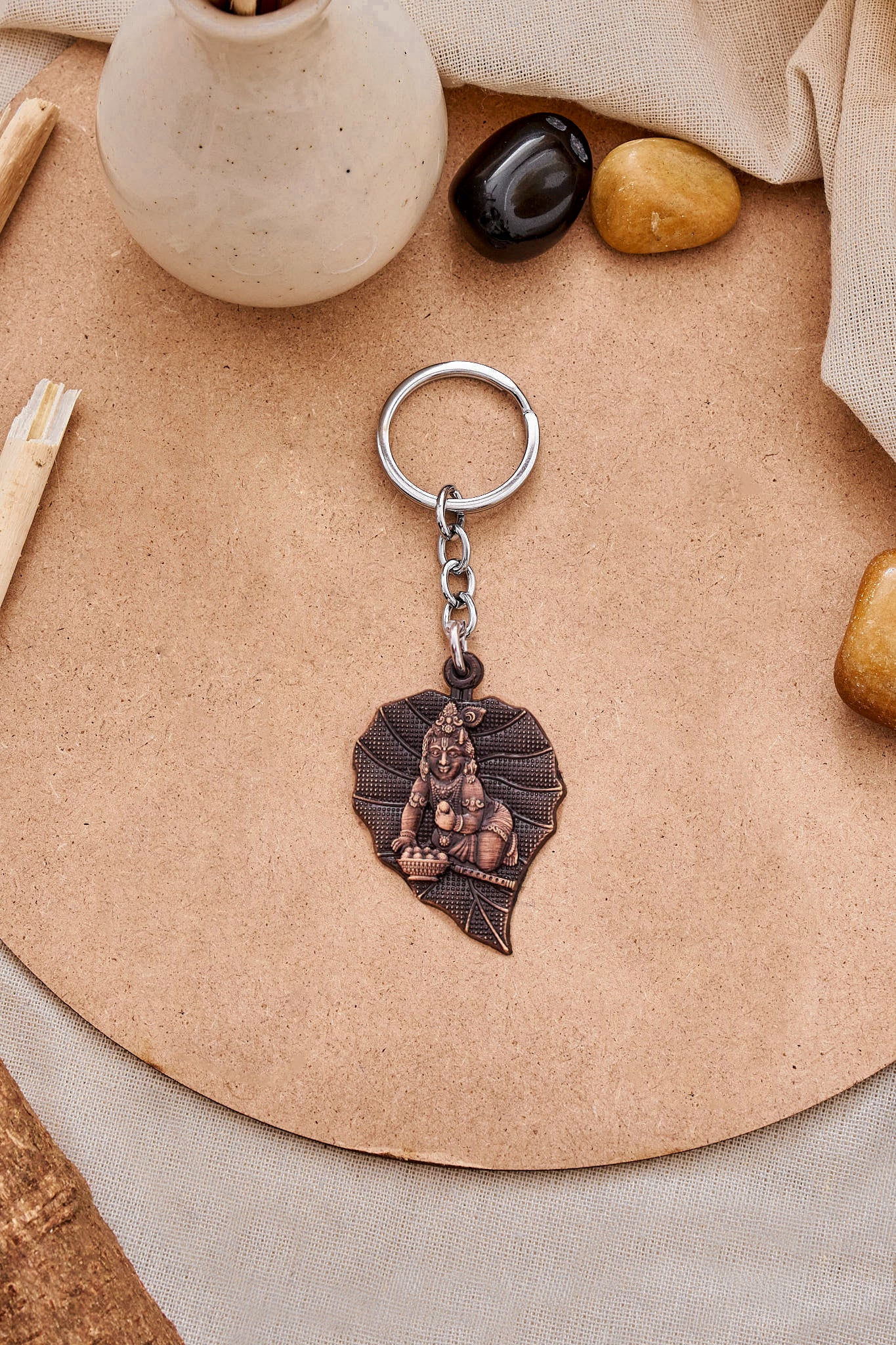 Baal Krishna leaf keychain with bronze finish and Krishna design