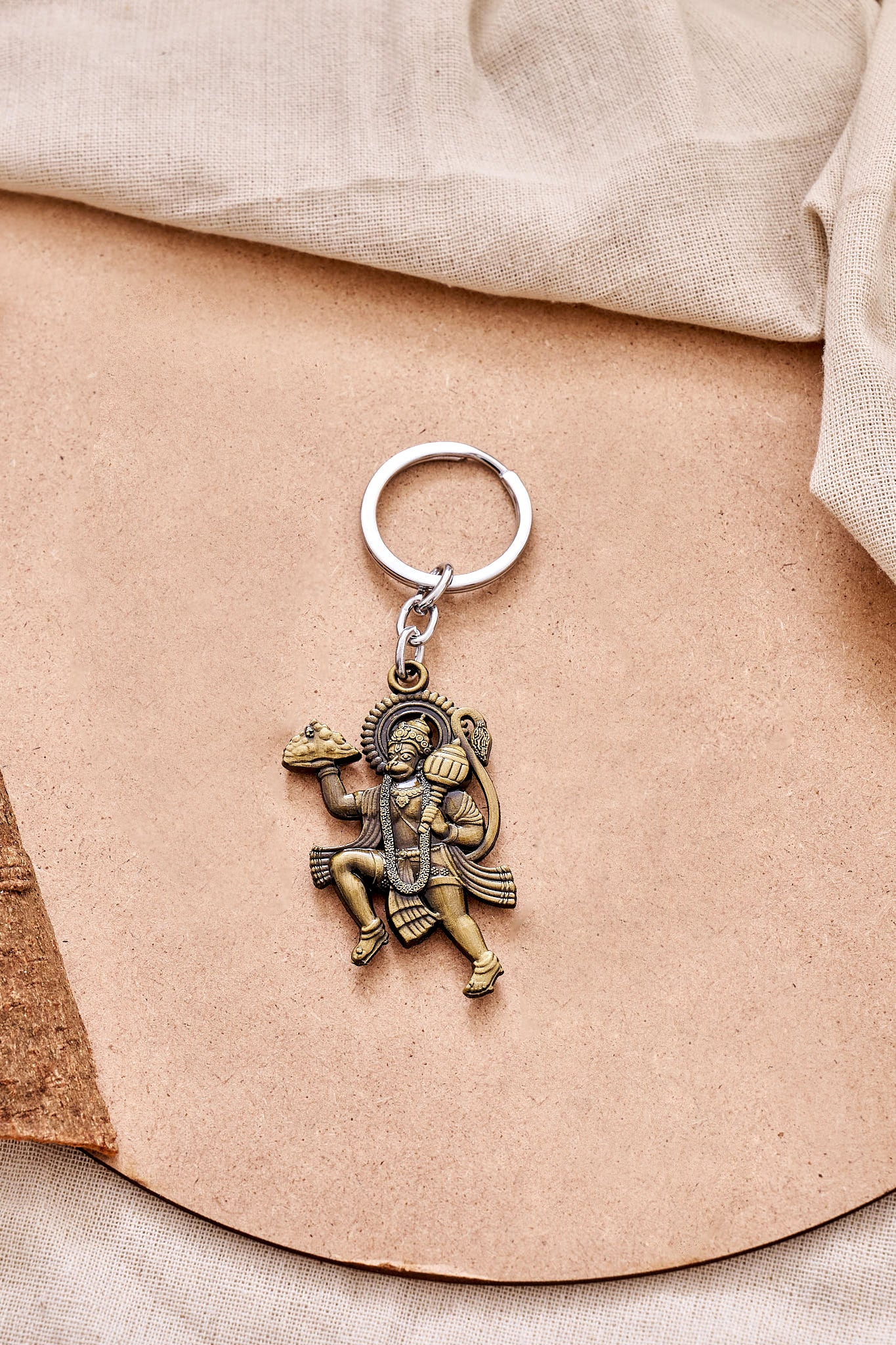Flying Hanuman keychain in gold featuring Lord Hanuman